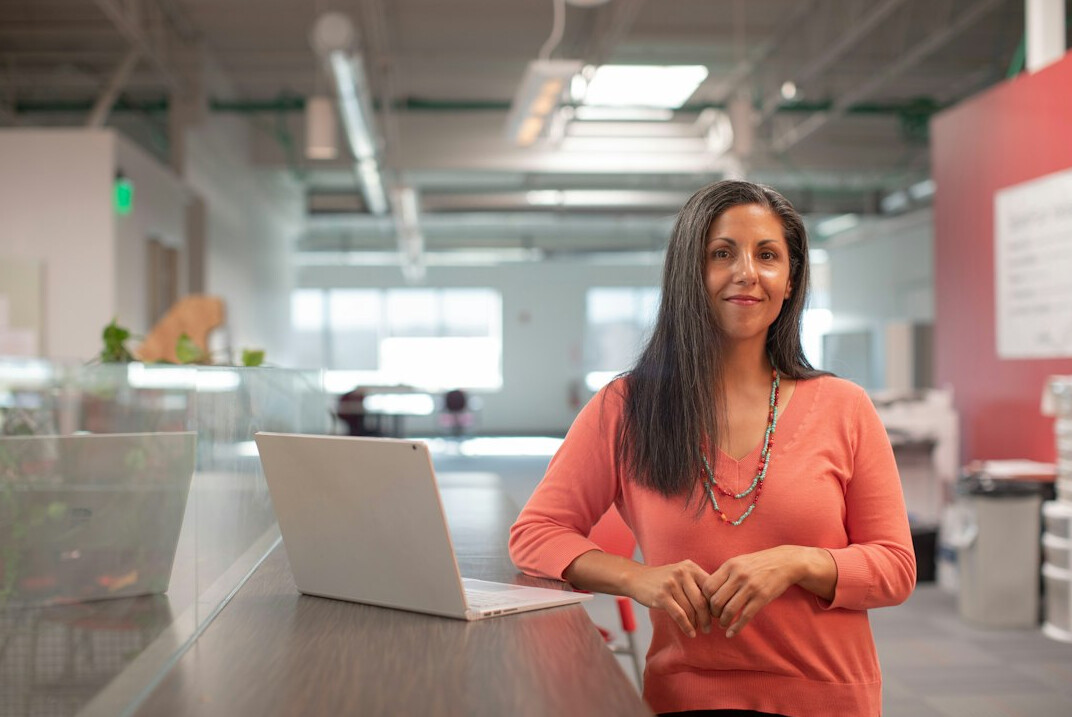young woman entrepreneur smiling in office