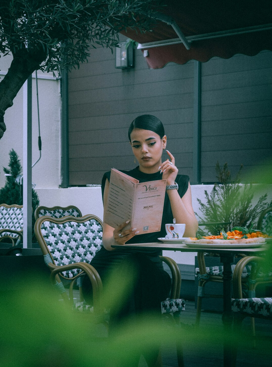 woman reading book in cafe
