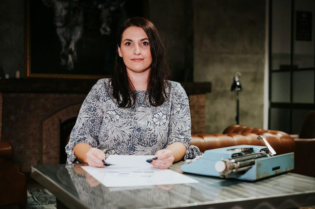 female author writing at desk