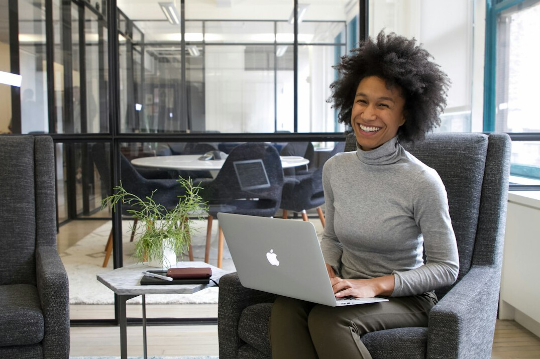 young woman entrepreneur smiling in office